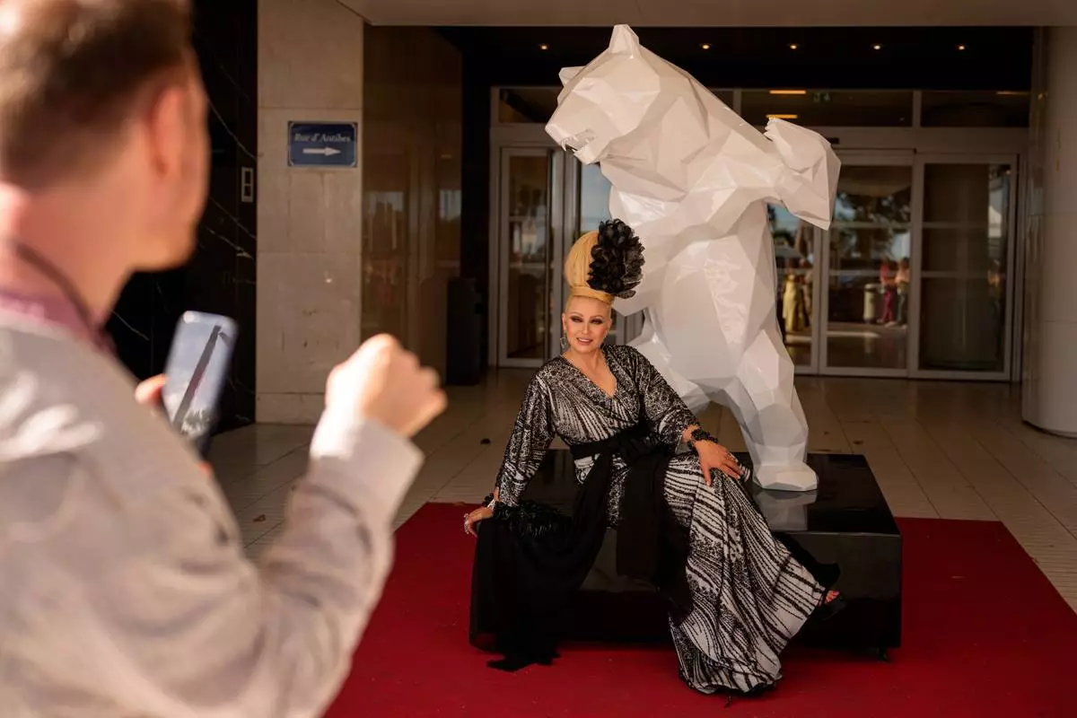 Elena Lenina poses for a photographer after walking on the red carpet for the movie "Parallel Talles" during the 79th international film festival, Cannes, southern France, Thursday, May 14, 2026. (AP Photo/Andreea Alexandru)