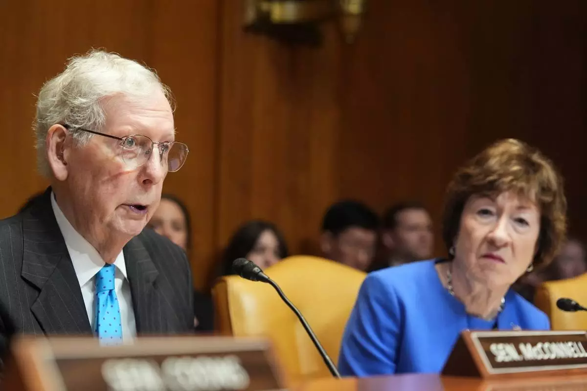 Sen. Mitch McConnell, R-Ky., speaks at Sen. Susan Collins, R-Maine, listens, at a Senate Appropriations subcommittee on defense hearing on the budget request for the Department of Defense with Defense Secretary Pete Hegseth, Chairman of the Joint Chiefs of Staff Gen. Dan Caine and acting Under Secretary of Defense and Comptroller Jules Hurst III, Tuesday, May 12, 2026, in Washington. (AP Photo/Alex Brandon)
