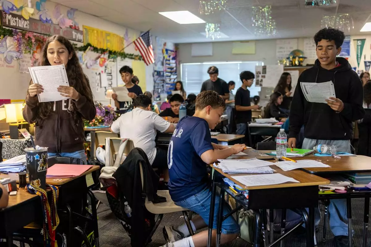 Sixth graders read a passage and give constructive feedback to their partners during Nancy Barajas' class at Fairview Elementary School on Wednesday, May 6, 2026, in Modesto, Calif. (AP Photo/Annie Barker)