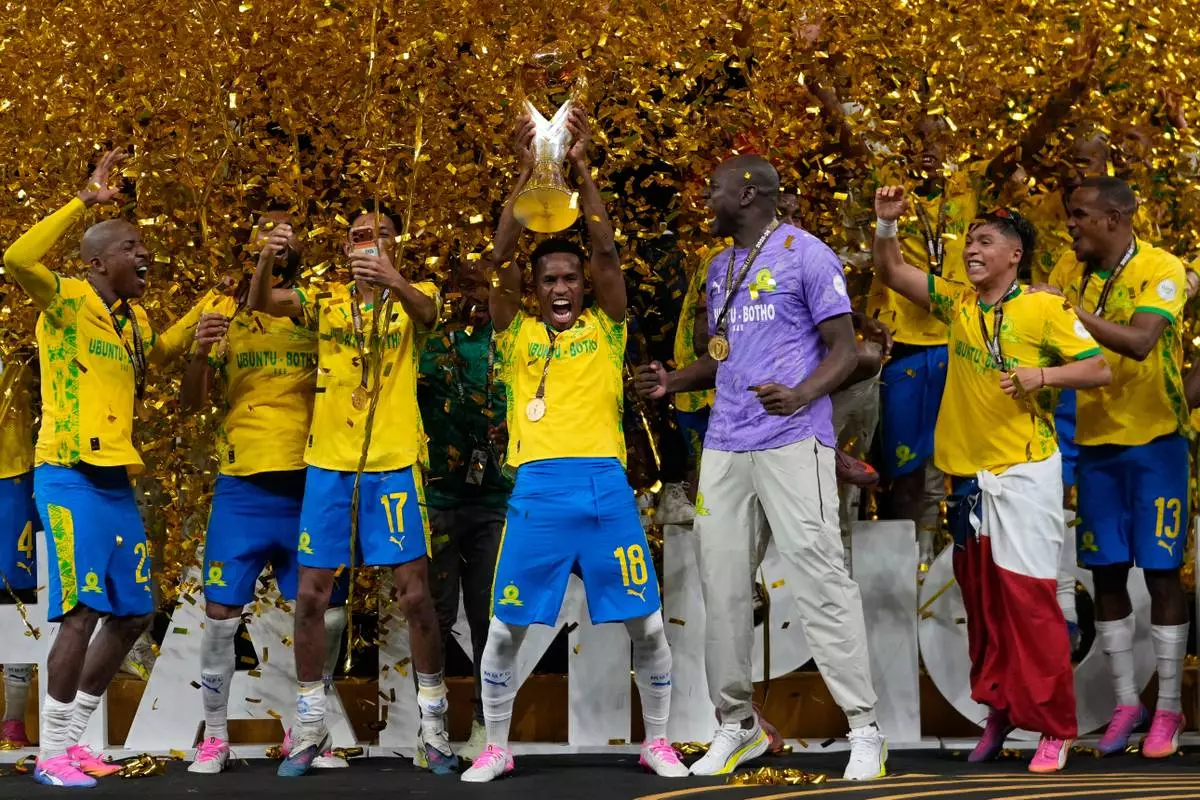 Mamelodi Sundowns' Themba Zwane, center, celebrates with his teammates after winning the CAF Champions League final soccer match between AS FAR Rabat and Mamelodi Sundowns, in Rabat, Morocco, Sunday, May 24, 2026. (AP Photo/Mosa'ab Elshamy)