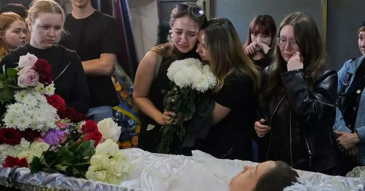 Young Kyiv couple killed in a fierce Russian airstrike hoped to start a family, mourners say