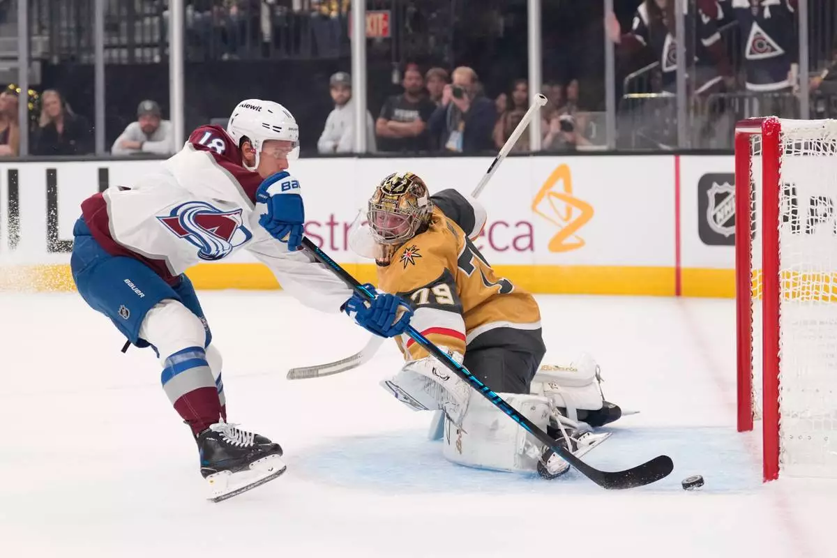 Colorado Avalanche's Jack Drury, left, scores on Vegas Golden Knights goaltender Carter Hart during the first period in Game 3 of the Western Conference finals NHL hockey Stanley Cup playoff series, Sunday, May 24, 2026, in Las Vegas. (AP Photo/Mark J. Terrill) CORRECTION: Name corrected to Jack Drury not Cale Makar.