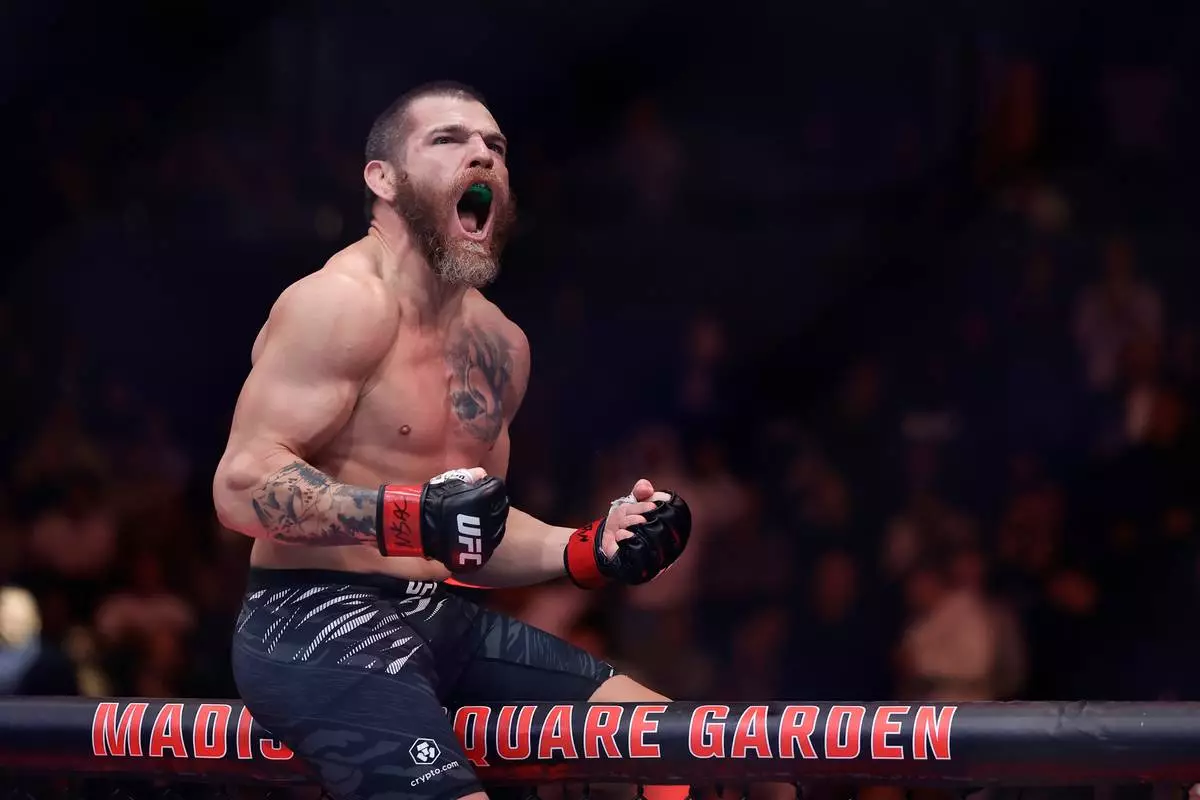 FILE - Jim Miller reacts after defeating Damon Jackson in a UFC 309 mixed martial arts lightweight title bout, Nov. 16, 2024, in New York. (AP Photo/Adam Hunger, File)