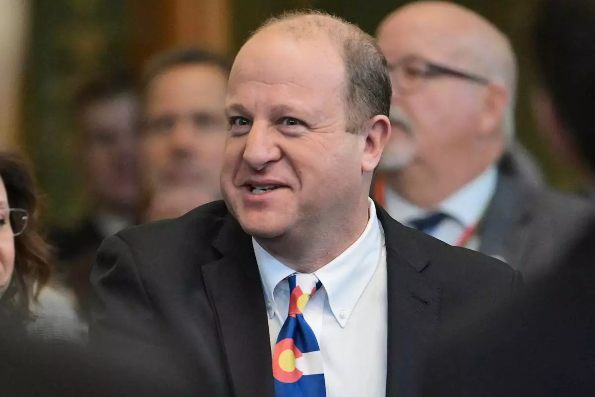 FILE - Colorado Gov. Jared Polis arrives in the House chamber of the Colorado State Capitol to deliver his state of the state address, Thursday, Jan. 9, 2025, in Denver. (Hyoung Chang/The Denver Post via AP, Pool, File)