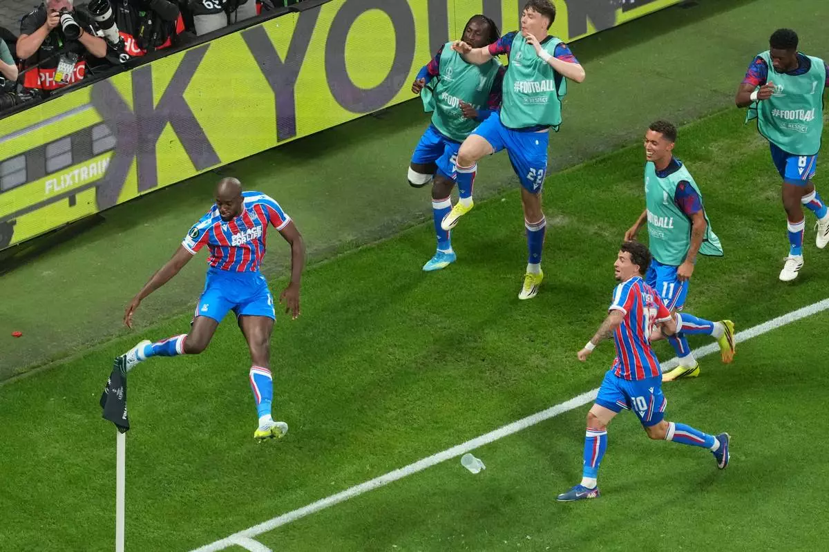 Crystal Palace's Jean-Philippe Mateta, left, celebrates with teammates after scoring his side's opening goal during the Europa Conference League final soccer match between Crystal Palace and Rayo Vallecano in Leipzig, Germany, Wednesday, May 27, 2026. (AP Photo/Markus Schreiber)