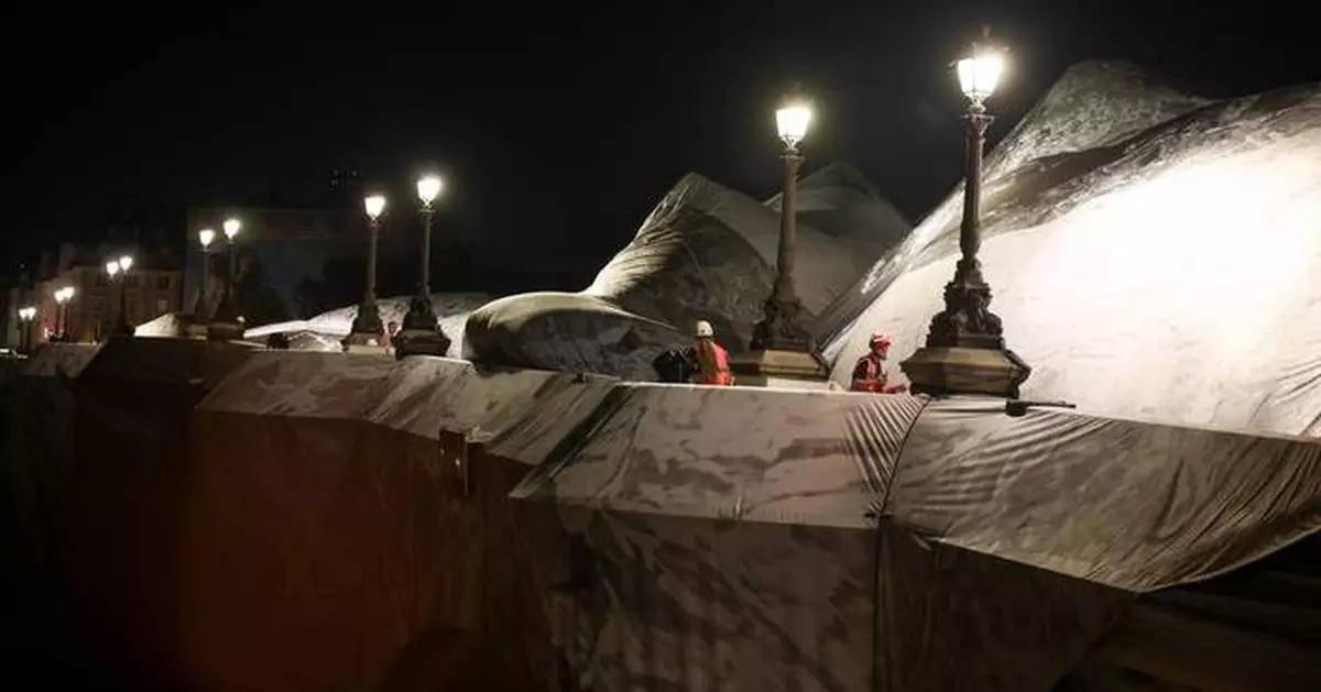 French artist JR begins his giant ‘cave’ art inflation over Paris’ oldest bridge