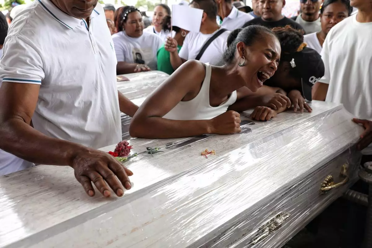 FILE - Relatives mourn during a funeral for victims who were killed in an attack on the Pan-American Highway that authorities blamed on dissident former FARC rebels, in Cajibio, Colombia, Tuesday, April 28, 2026. (AP Photo/Santiago Saldarriaga, File)
