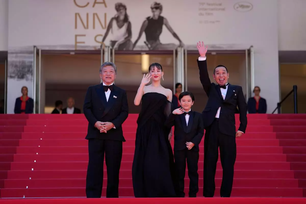Director Hirokazu Kore-eda, from left, Haruka Ayase, Rimu Kuwaki, and Daigo Yamamoto pose for photographers upon arrival at the premiere of the film 'Sheep in the Box' at the 79th international film festival, Cannes, southern France, Saturday, May 16, 2026. (AP Photo/John Locher)