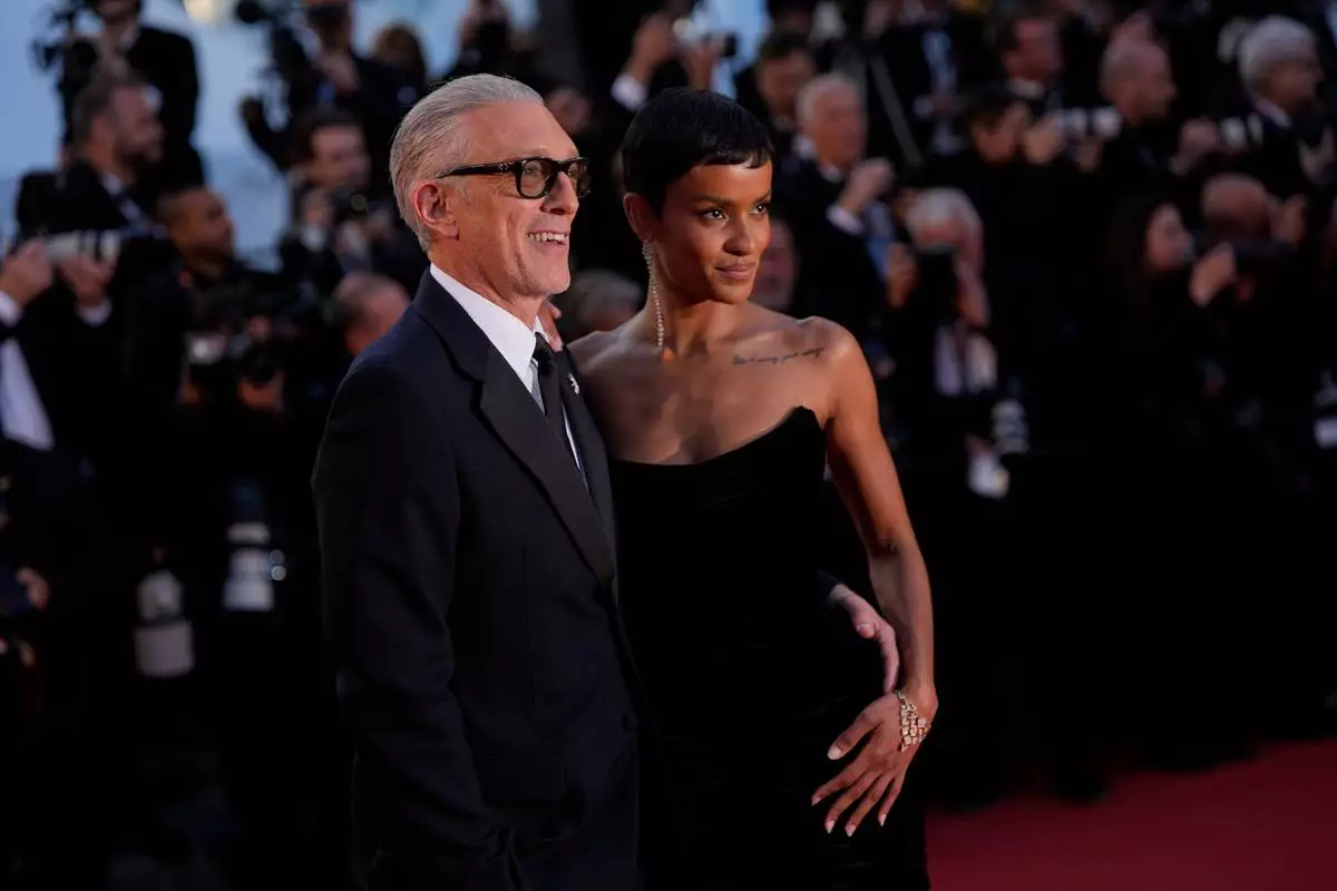 Vincent Cassel, left, and Narah Baptista pose for photographers upon arrival at the premiere of the film 'Parallel Tales' at the 79th international film festival, Cannes, southern France, Thursday, May 14, 2026. (AP Photo/John Locher)