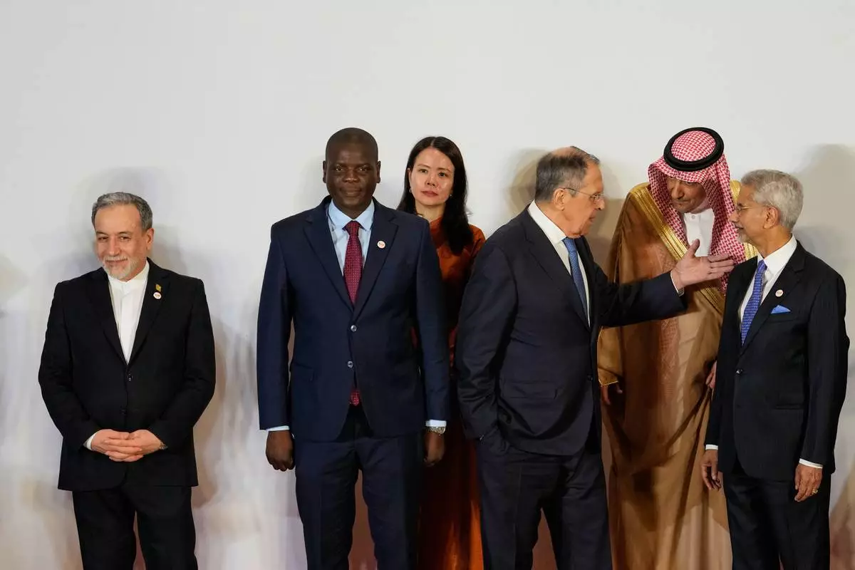Russia's Foreign Minister Sergey Lavrov, third right, talks to Vice Minister of Foreign Affairs of Saudi Arabia, Waleed bin Abdulkarim, second right, as Indian Foreign Minister S.Jaishankar, right, South Africa's Minister of Foreign Affairs Ronald Lamola, second left, Iranian Foreign Minister Abbas Araghchi, left, and and Vietnam Deputy Foreign Minister Nguyen Hang, third left, watch at a photo call of Government representatives and partner countries of BRICS during a two day meeting in New Delhi, India, Thursday, May 14, 2026. (AP Photo/Manish Swarup)