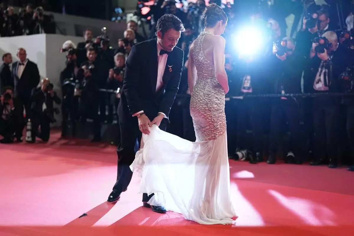 Miles Teller, left, and Keleigh Sperry pose for photographers upon arrival at the premiere of the film 'Paper Tiger' at the 79th international film festival, Cannes, southern France, Saturday, May 16, 2026. (Photo by Scott A Garfitt/Invision/AP)