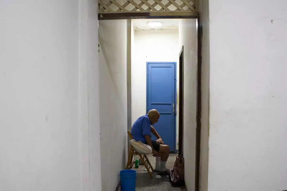Jose Breijo, a dual citizen of Uruguay and Venezuela, sits in his apartment in Caracas, Venezuela, Wednesday, May 27, 2026, after being released following two years in prison on terrorism charges. (AP Photo/Ariana Cubillos)