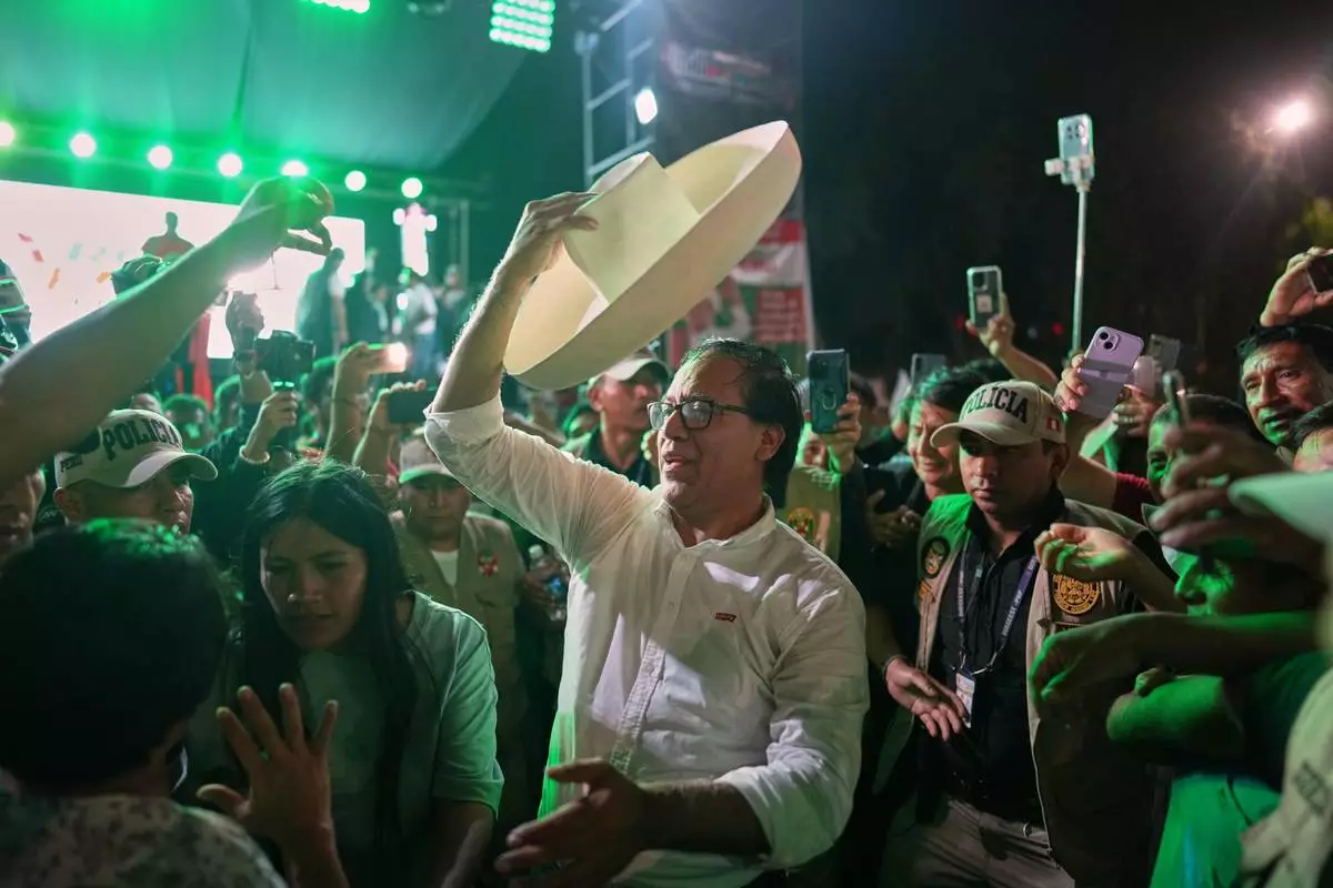 Presidential candidate Roberto Sanchez of Together for Peru party waves supporters as he arrives at rally in Trujillo, Peru, Saturday, May 23, 2026. (AP Photo/ Rodrigo Abd)