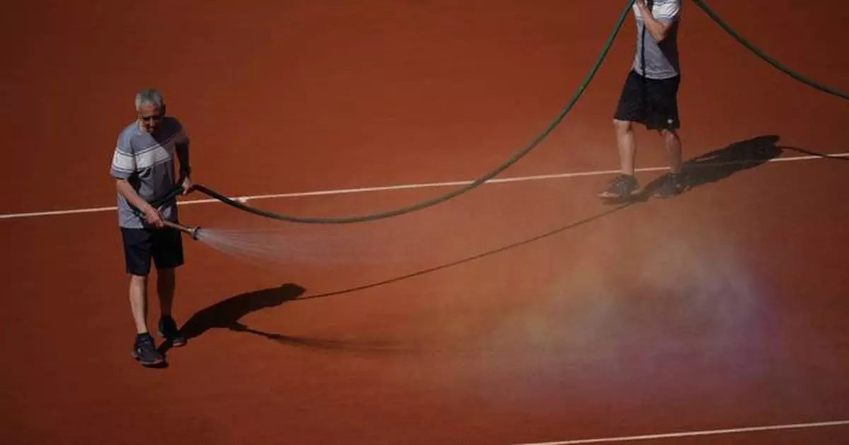 French Open groundskeepers drench the clay courts with water and salt during heat wave
