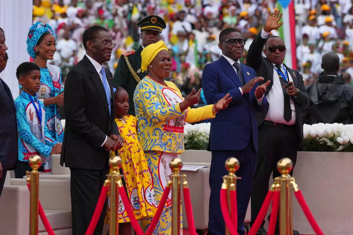 Front row, from left, Equatorial Guinea President Teodoro Obiang Nguema Mbasogo, first lady Constancia Mangue Nsue Okomo, and Equatorial Guinea Vice President Teodoro Nguema Obiang attend a Holy Mass with Pope Leo XIV at the Malabo Stadium in Malabo, Equatorial Guinea, Thursday, April 23, 2026. (AP Photo/Misper Apawu)