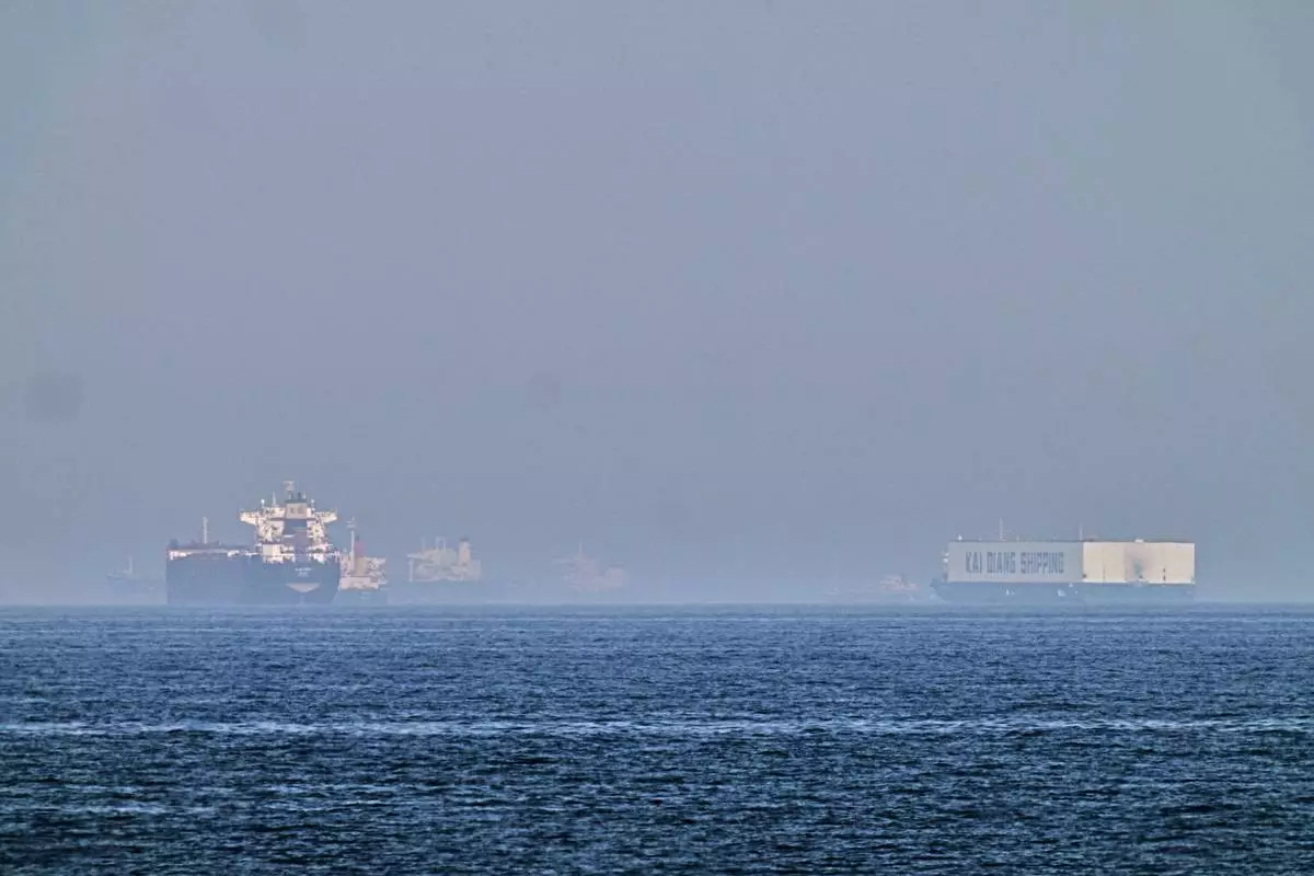 A tanker, left, and a car carrier are anchored at sea in the Gulf of Oman near the Strait of Hormuz, as seen from the coast near Khor Fakkan, United Arab Emirates, Friday, May 1, 2026.(AP Photo/Fatima Shbair)