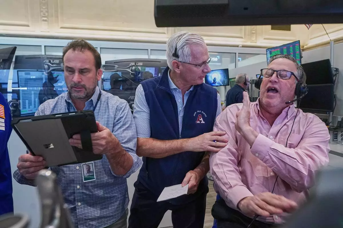 Options trader, left to right, Scott Frinzi, Dave Rushand and Marty Handler, work on the floor of the New York Stock Exchange, Friday, May 1, 2026. (AP Photo/Richard Drew)
