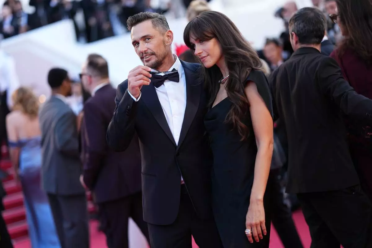 James Franco, left, and Izabel Pakzad pose for photographers at the opening ceremony and premiere of the film 'The Electric Kiss' during 79th international film festival, Cannes, southern France, Tuesday, May 12, 2026. (Photo by Scott A Garfitt/Invision/AP)