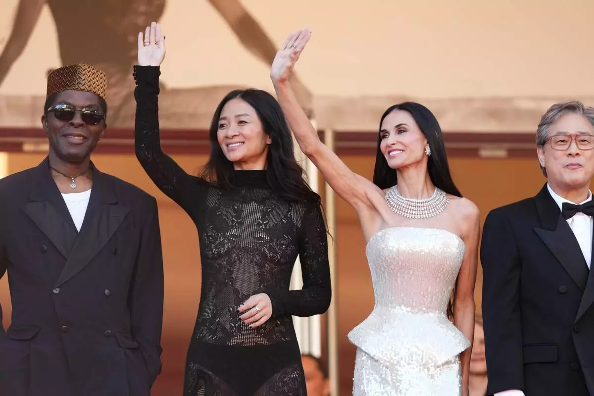 Jury president Park Chan-wook, fourth from left, poses with jury members Isaach de Bankolé, from left, Chloé Zhao and Demi Moore at the opening ceremony and premiere of the film 'The Electric Kiss' during 79th international film festival, Cannes, southern France, Tuesday, May 12, 2026. (Photo by Scott A Garfitt/Invision/AP)