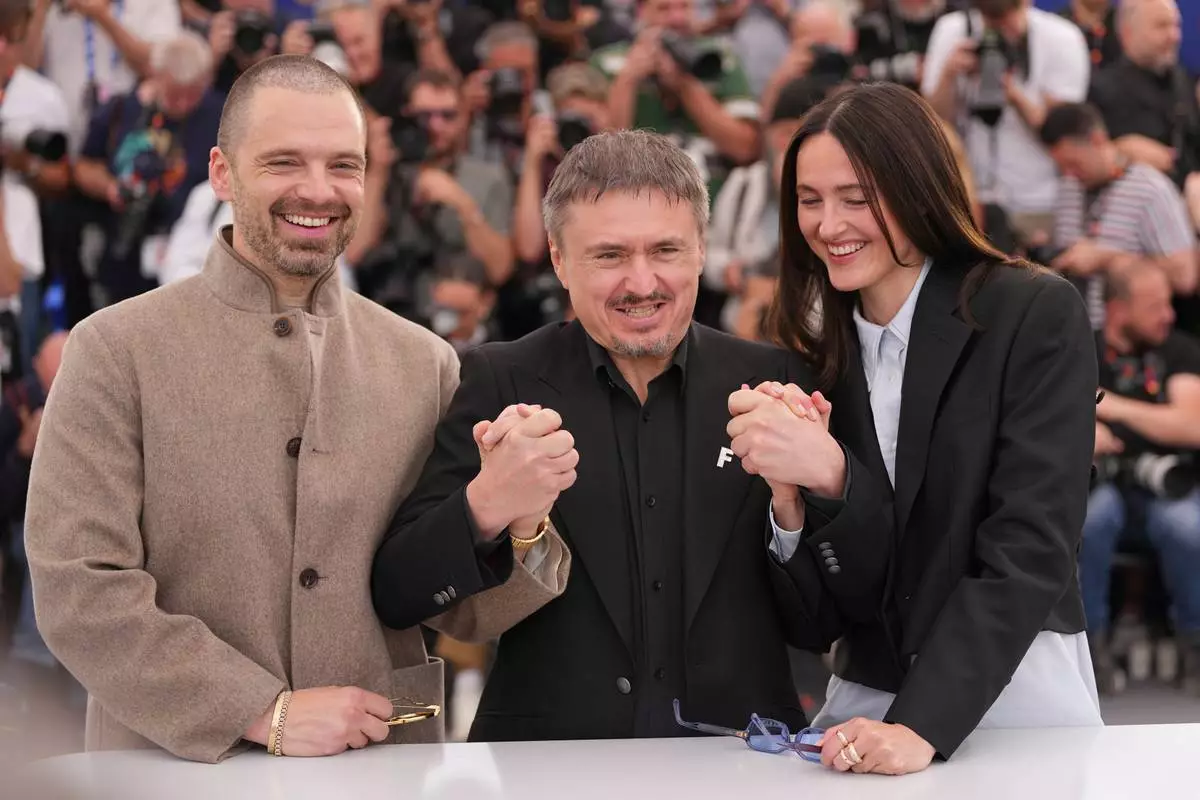 Sebastian Stan, from left, director Cristian Mungiu and Renate Reinsve pose for photographers at the photo call for the film 'Fjord' during the 79th international film festival, Cannes, southern France, Tuesday, May 19, 2026. (AP Photo/Andreea Alexandru)