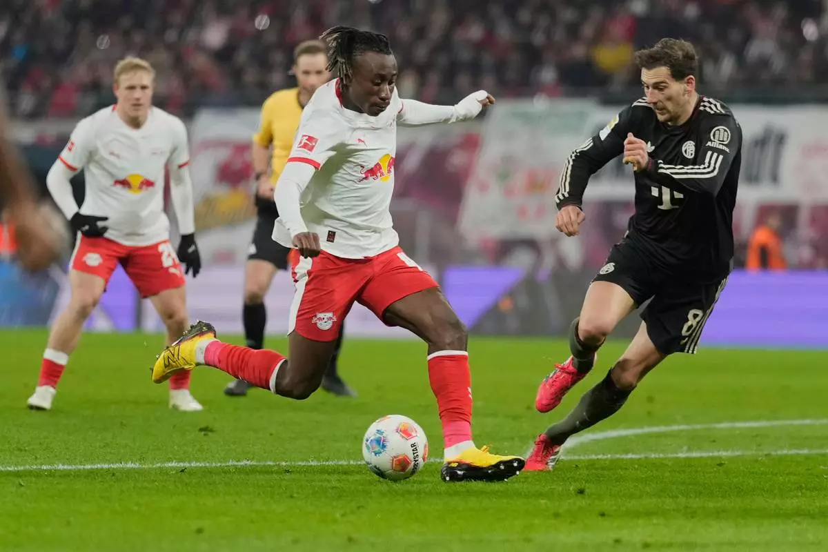 FILE - Leipzig's Yan Diomande, centre, and Bayern's Leon Goretzka challenge for the ball during the Bundesliga soccer match between RB Leipzig and FC Bayern Munich in Leipzig, Germany, on Jan. 17, 2026. (AP Photo/Matthias Schrader, File)