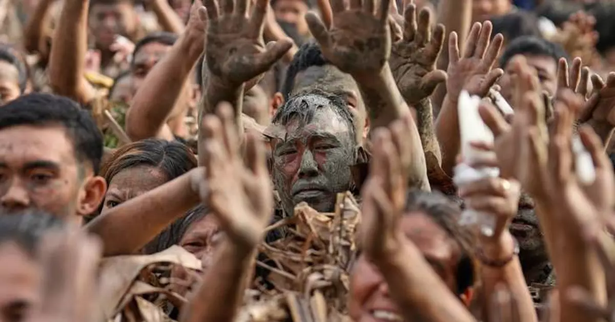 Photos show Philippine Catholics smearing mud on their bodies for festival honoring John the Baptist