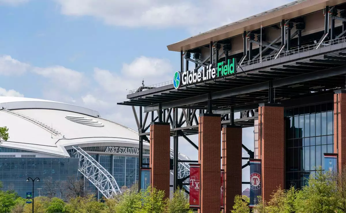 FILE - The facade of Globe Life Field stands in front of the Dallas Cowboys' AT&T Stadium before a baseball game between the Texas Rangers and the Toronto Blue Jays, April 5, 2021, in Arlington, Texas. (AP Photo/Jeffrey McWhorter, File)