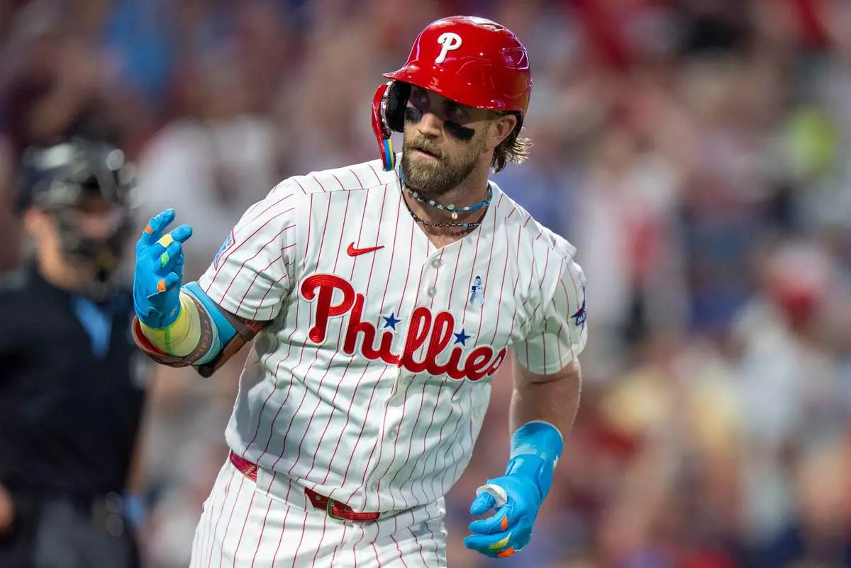 Philadelphia Phillies' Bryce Harper reacts to his solo home run during the fifth inning of a baseball game against the New York Mets, Sunday, June 21, 2026, in Philadelphia. (AP Photo/Chris Szagola) CORRECTION: His home run was in the fifth not the fourth inning.