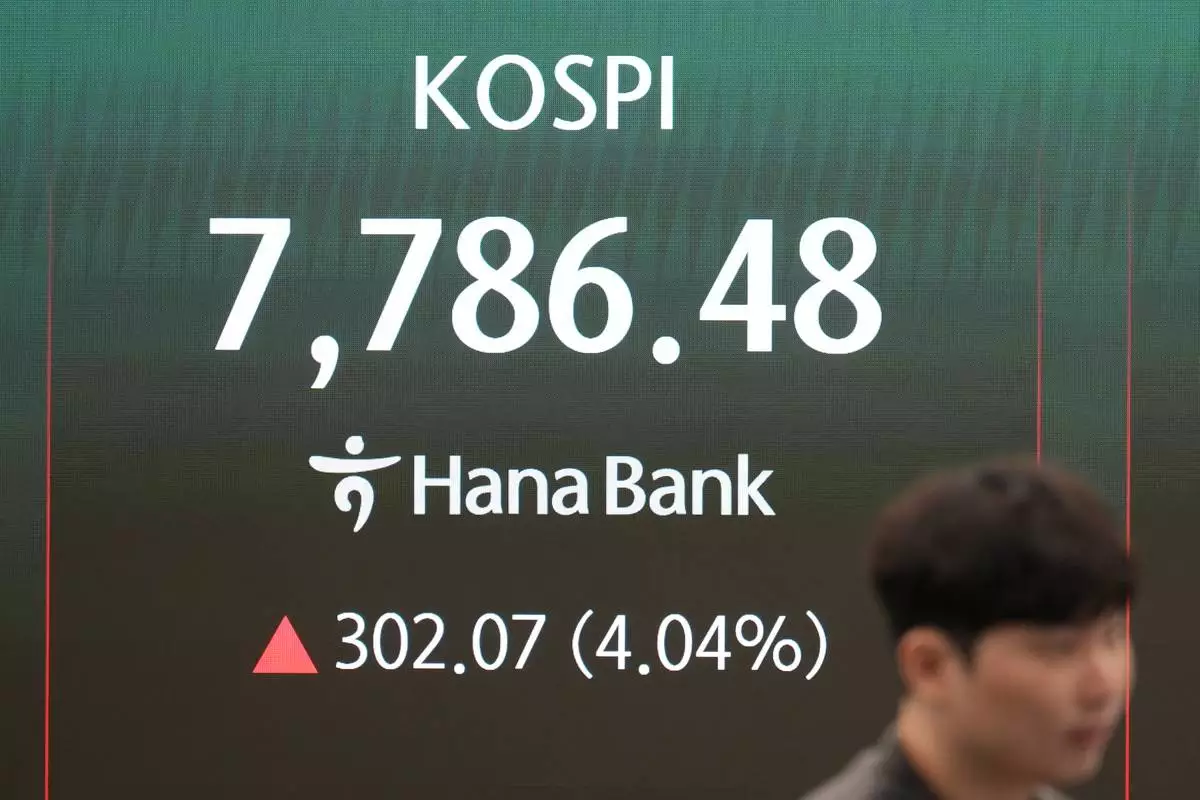 A dealer stands near the screen showing the Korea Composite Stock Price Index (KOSPI) at a dealing room of Hana Bank in Seoul, South Korea, Tuesday, June 9, 2026. (AP Photo/Lee Jin-man)