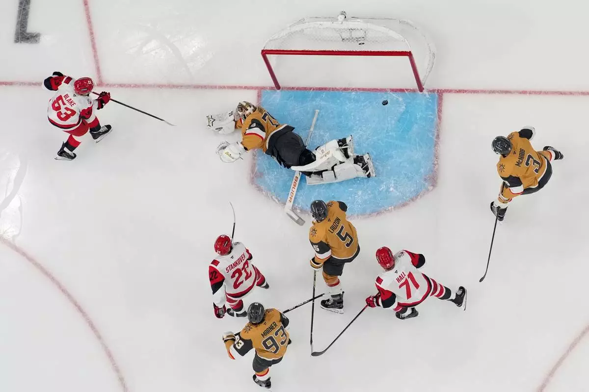 Carolina Hurricanes right wing Jackson Blake (53) scores against Vegas Golden Knights goaltender Carter Hart (79) during the first period in Game 4 of the NHL hockey Stanley Cup Final series , Tuesday, June 9, 2026, in Las Vegas. (AP Photo/John Locher)