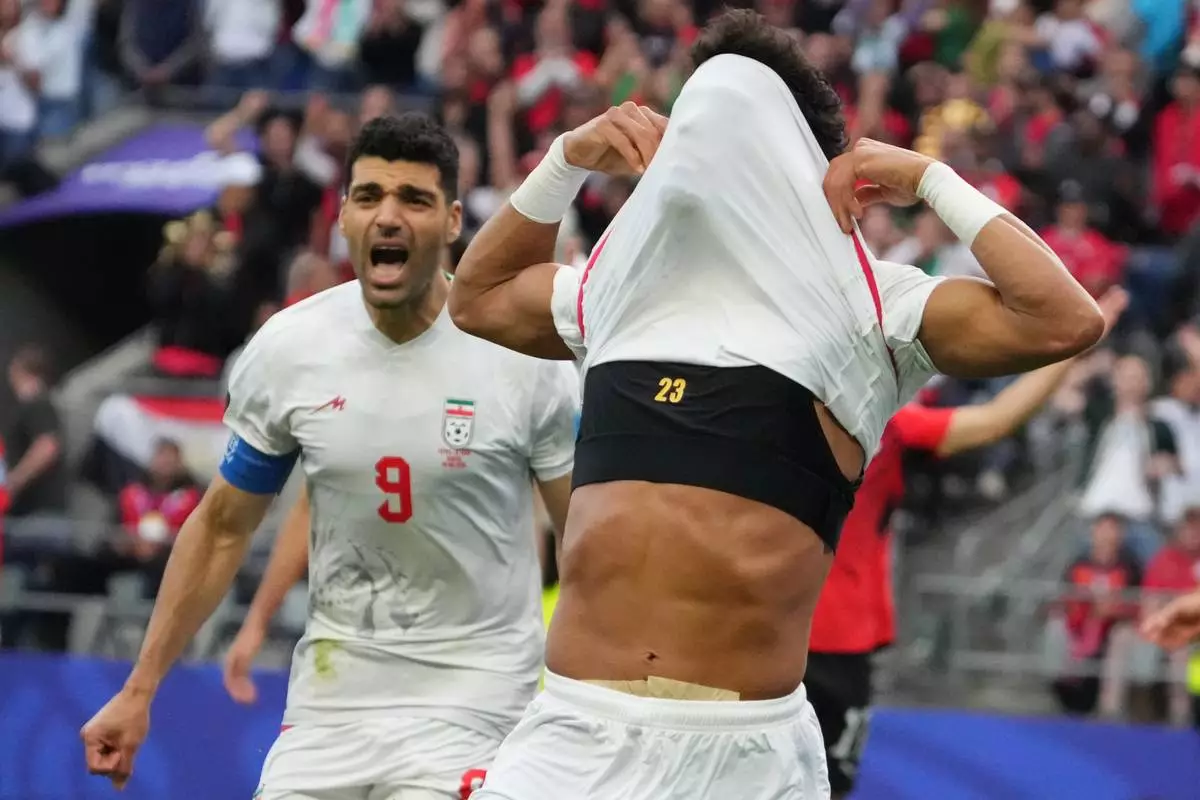 Iran's Ramin Rezaeian (23) celebrates after scoring during the World Cup Group G soccer match between Egypt and Iran in Seattle, Friday, June 26, 2026. (AP Photo/Ted S. Warren)