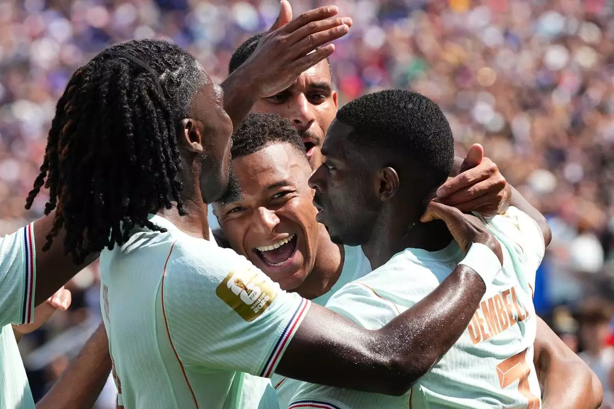France's Ousmane Dembele, right, celebrates with Kylian Mbappe, center, and other teammates after scoring his side's third goal during the World Cup Group I soccer match between Norway and France in Foxborough, Mass., near Boston, Friday, June 26, 2026. (AP Photo/Martin Meissner)