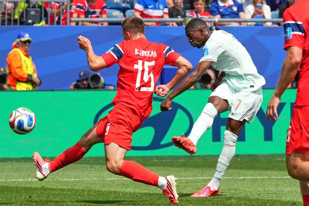 France's Ousmane Dembele, right, scores the opening goal during the World Cup Group I soccer match between Norway and France in Foxborough, Mass., near Boston, Friday, June 26, 2026. (AP Photo/Martin Meissner)
