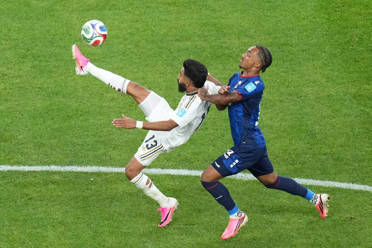Saudi Arabia's Nawaf Bu Washl (13) kicks the ball against Cape Verde's Dailon Livramento (19) during the World Cup Group H soccer match between Cape Verde and Saudi Arabia in Houston, Friday, June 26, 2026. (AP Photo/Eric Gay)