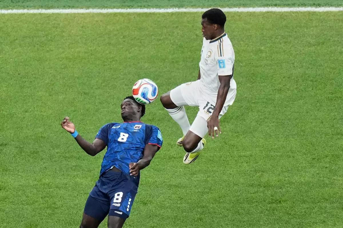 Saudi Arabia's Saud Abdulhamid (12) and Cape Verde's Joao Paulo (8) look to control the ball during the World Cup Group H soccer match between Cape Verde and Saudi Arabia in Houston, Friday, June 26, 2026. (AP Photo/Eric Gay)