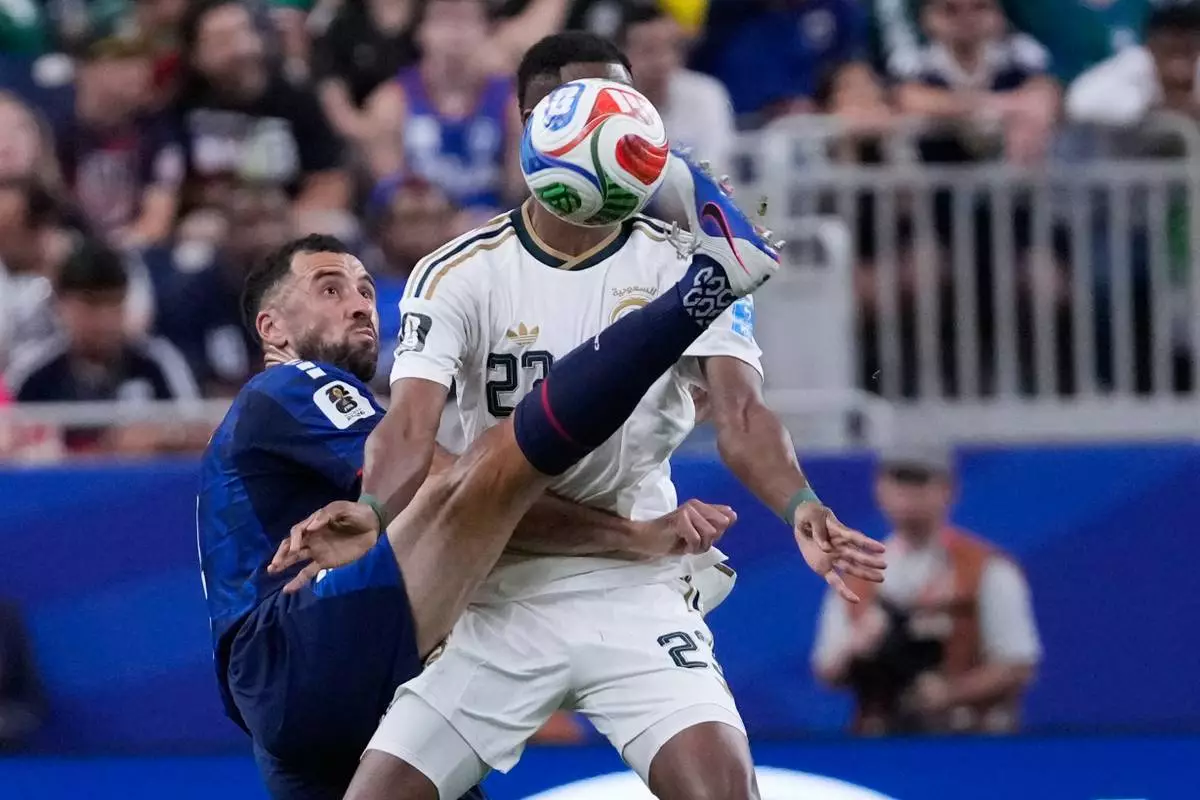 Cape Verde's Pico Lopes, left, and Saudi Arabia's Mohamed Kanno (23) battle for the ball during the World Cup Group H soccer match between Cape Verde and Saudi Arabia in Houston, Friday, June 26, 2026. (AP Photo/David J. Phillip)