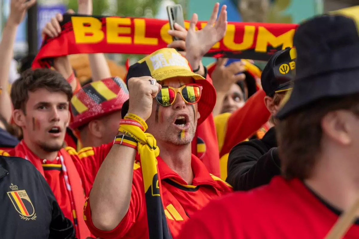 Belgium fans march toward B.C. Place prior to a World Cup Group G soccer match against New Zealand, in Vancouver, on Friday, June 26, 2026. (Timothy Matwey/The Canadian Press via AP)