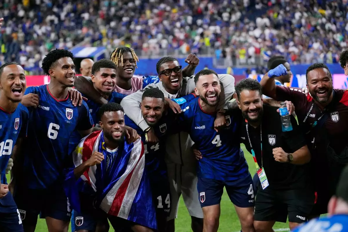 Cape Verde players celebrate their 0-0 draw with Saudi Arabia after the World Cup Group H soccer match in Houston, Friday, June 26, 2026. (AP Photo/David J. Phillip)