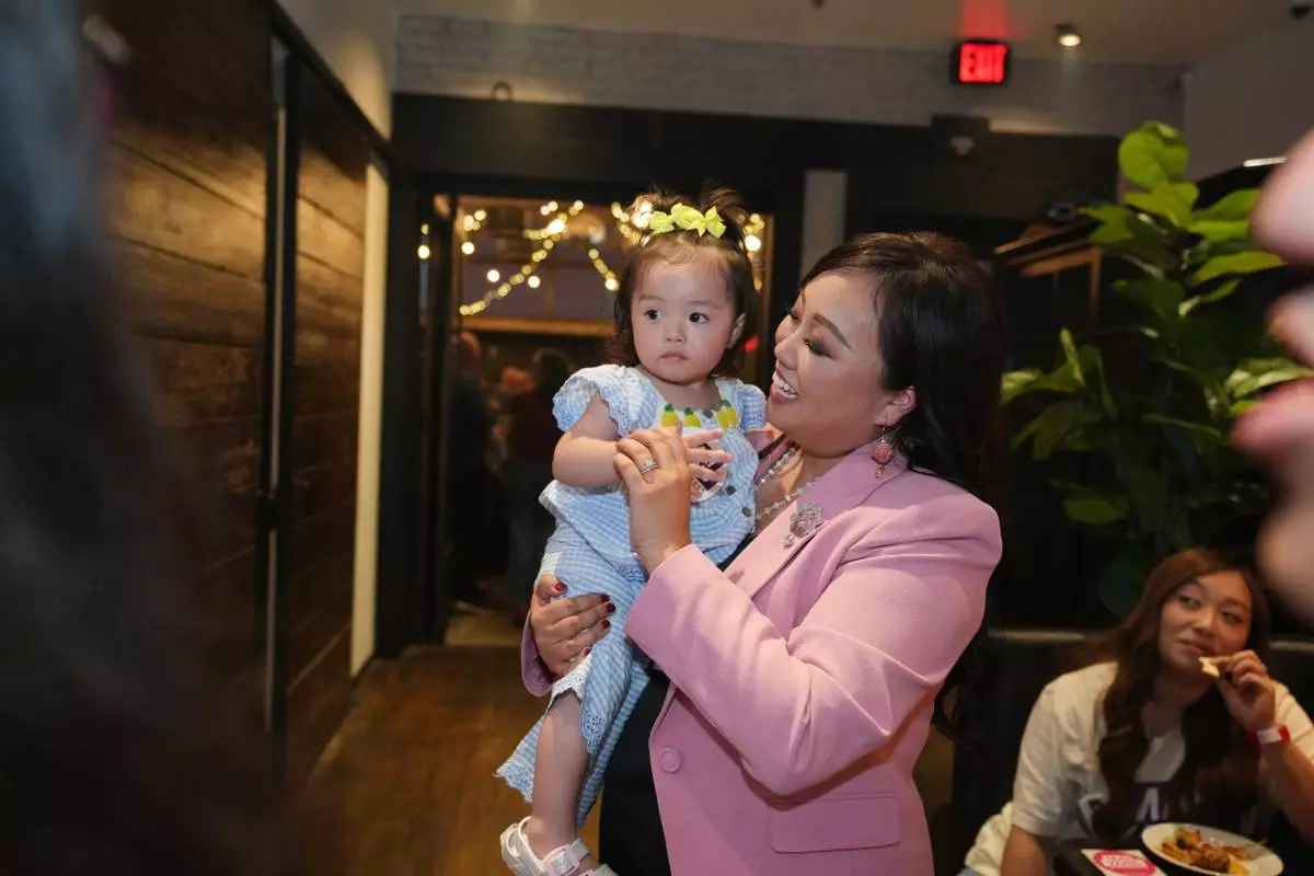 Sacramento council member Mai Vang, who is running for Congress, holds a child during an election night party in Sacramento, Calif., Tuesday,, June 2, 2026.(AP Photo/Rich Pedroncelli)