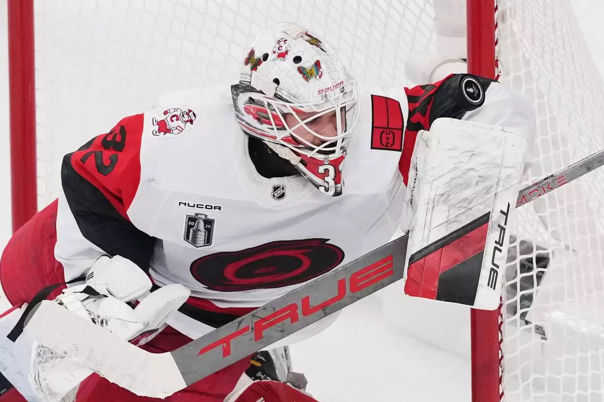 Carolina Hurricanes goaltender Brandon Bussi (32) stops a shot on goal during the first period in Game 6 of the NHL hockey Stanley Cup Final series against the Vegas Golden Knights, Sunday, June 14, 2026, in Las Vegas. (AP Photo/Candice Ward)