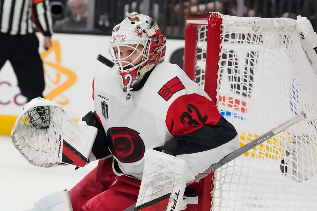 Carolina Hurricanes goaltender Brandon Bussi (32) stops a shot on goal during the second period in Game 6 of the NHL hockey Stanley Cup Final series against the Vegas Golden Knights, Sunday, June 14, 2026, in Las Vegas. (AP Photo/John Locher)