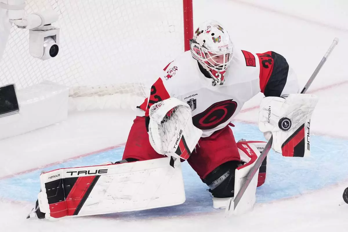 Carolina Hurricanes goaltender Brandon Bussi (32) stops a shot on goal during the second period in Game 6 of the NHL hockey Stanley Cup Final series against the Vegas Golden Knights, Sunday, June 14, 2026, in Las Vegas. (AP Photo/Candice Ward)