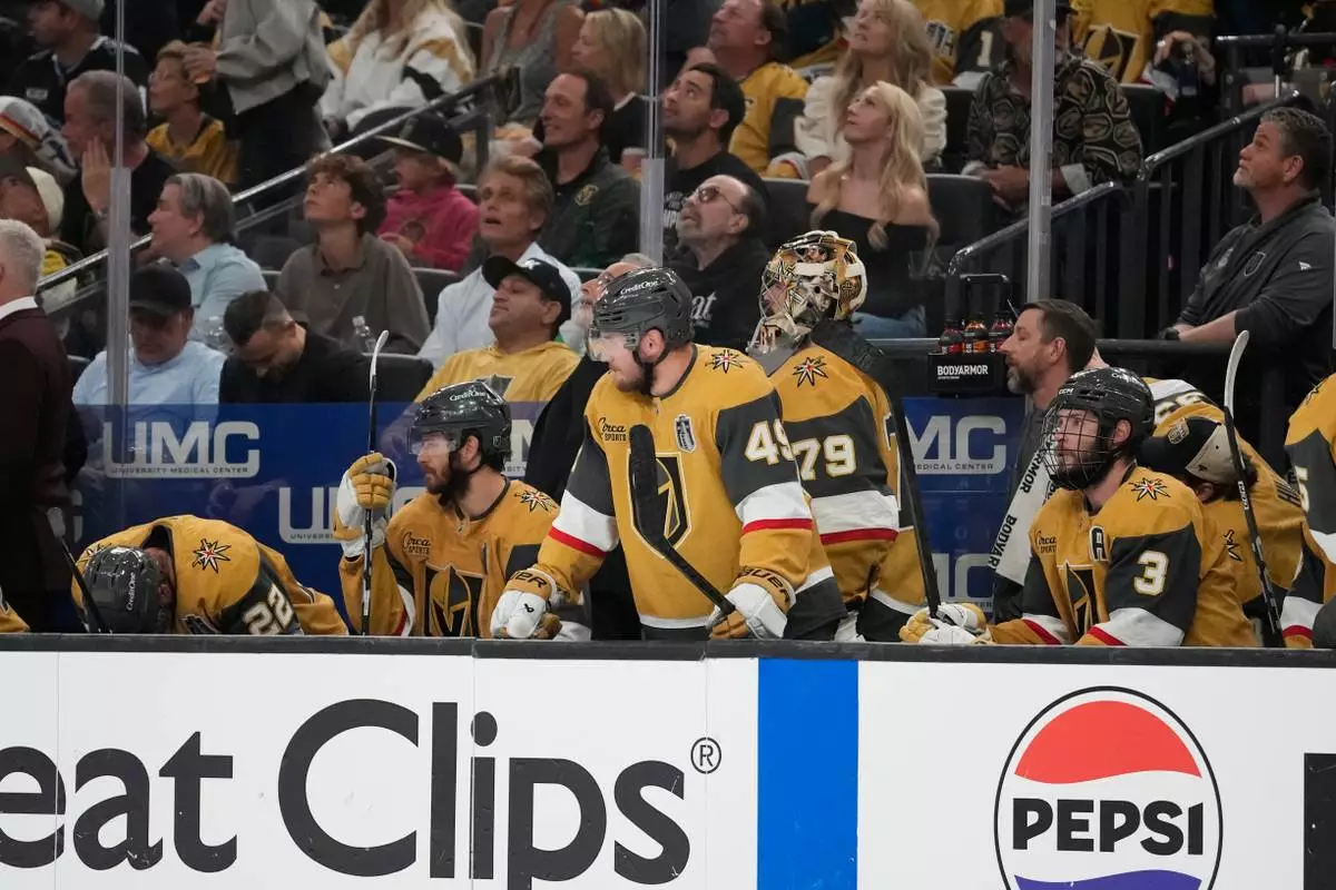 Vegas Golden Knights players watch from the bench during the third period in Game 6 of the NHL hockey Stanley Cup Final series against the Carolina Hurricanes, Sunday, June 14, 2026, in Las Vegas. (AP Photo/John Locher)