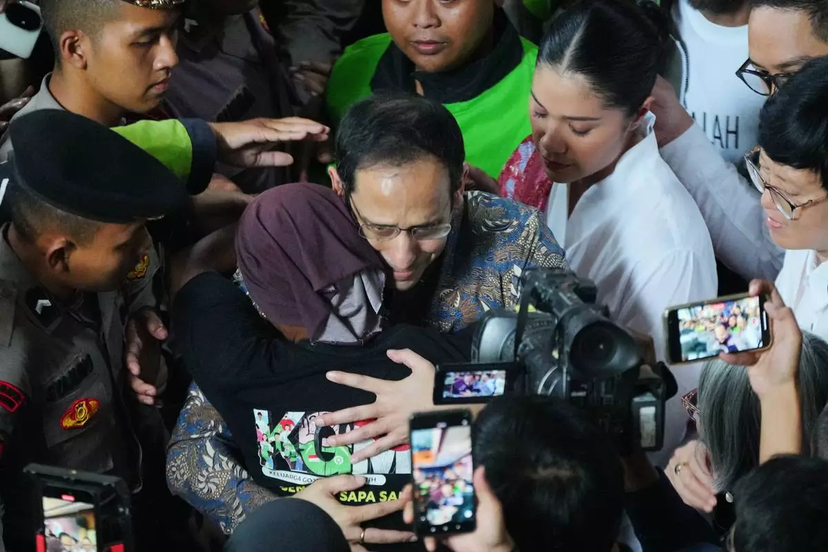 The co-founder of ride-hailing and payment giant Gojek and fomer Indonesian Education Minister Nadiem Anwar Makarim, center, is hugged by a supporter as his wife Franka, top right, looks on after being sentenced in a Google Chromebook laptop procurement corruption case, at the Corruption Court in Jakarta, Indonesia, Tuesday, June 30, 2026. (AP Photo/Tatan Syuflana)