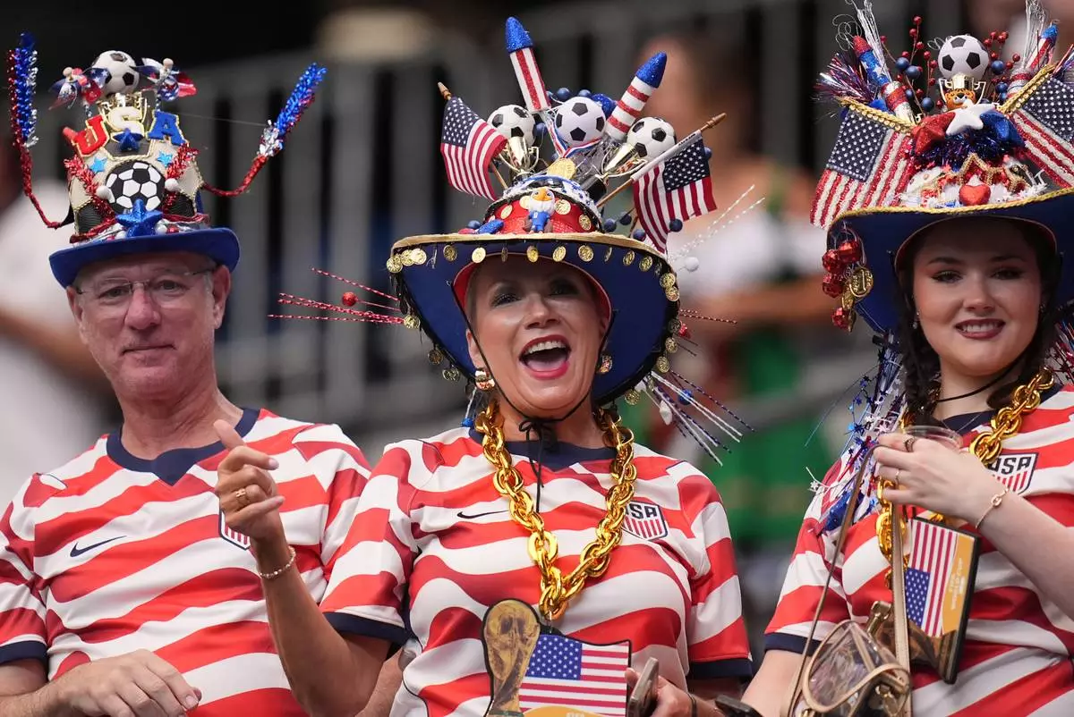 Fans wearing U.S.-themed clothing cheer before the World Cup Group E soccer match between Germany and Curacao in Houston, Sunday, June 14, 2026. (AP Photo/Eric Gay) CORRECTION: Removes country of fans