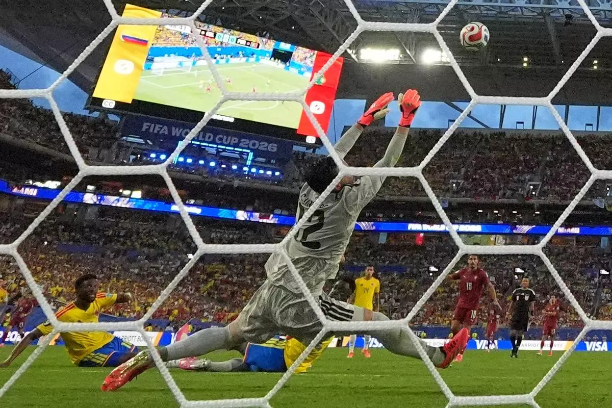 Colombia goalkeeper Camilo Vargas (12) makes a save during the World Cup Group K soccer match between Colombia and Portugal in Miami Gardens, Fla., Saturday, June 27, 2026. (AP Photo/Rebecca Blackwell)