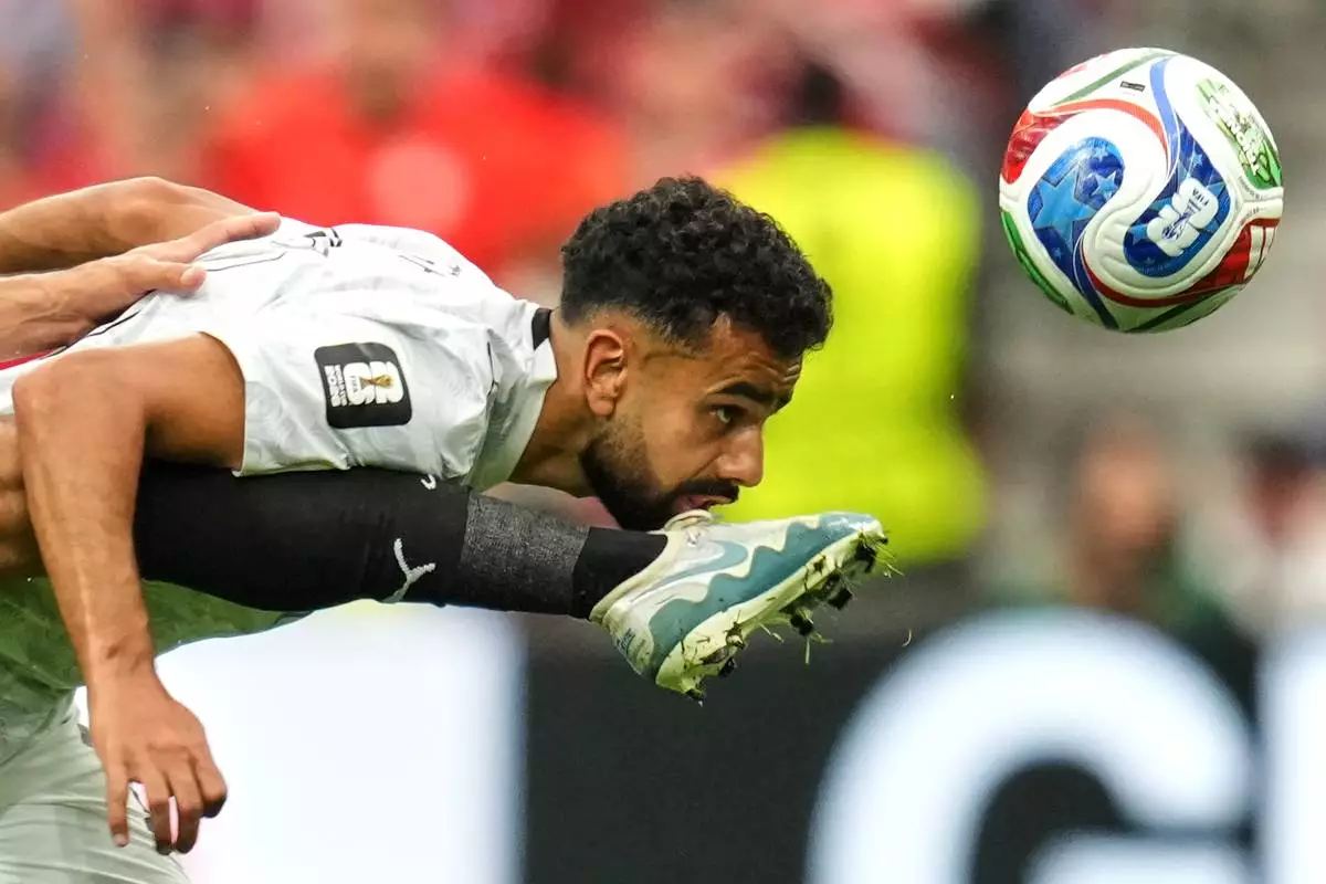 Egypt's Mohanad Lashin battles for the ball with New Zealand's Sarpreet Singh, right, during the World Cup Group G soccer match between New Zealand and Egypt in Vancouver, British Columbia, Sunday, June 21, 2026. (AP Photo/Abbie Parr)
