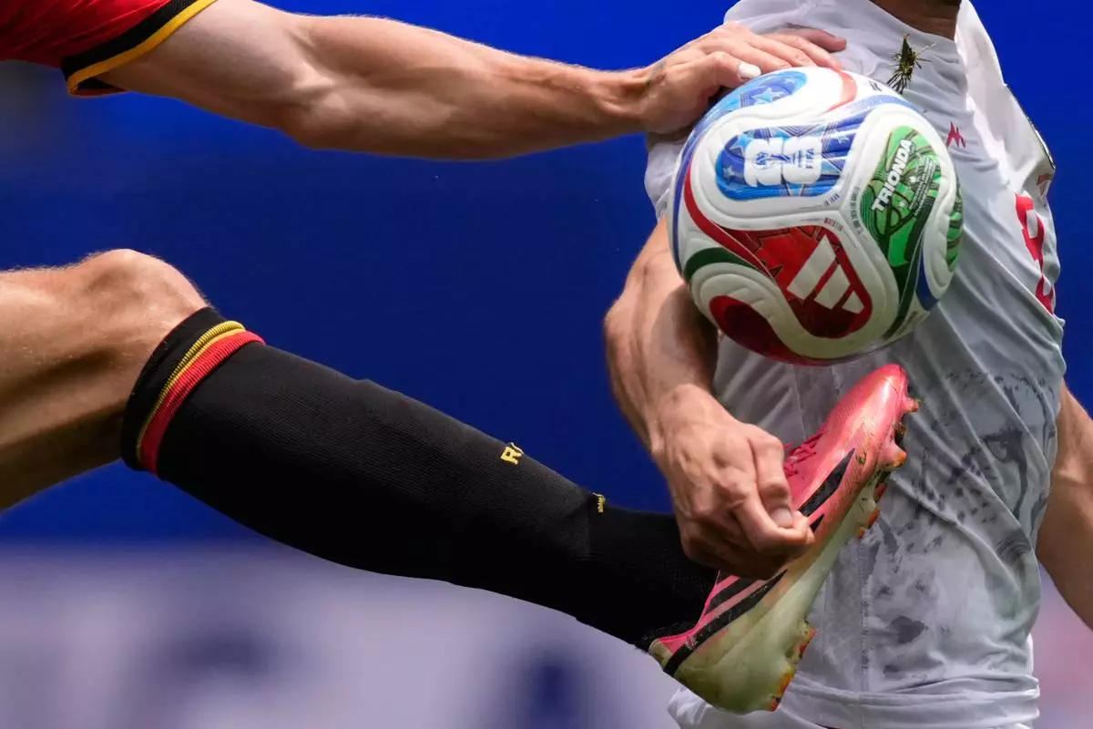 Belgium's Thomas Meunier, left, and Iran's Mehdi Taremi fight for the ball during the World Cup Group G soccer match in Inglewood, Calif., near Los Angeles, Sunday, June 21, 2026. (AP Photo/Mark J. Terrill)