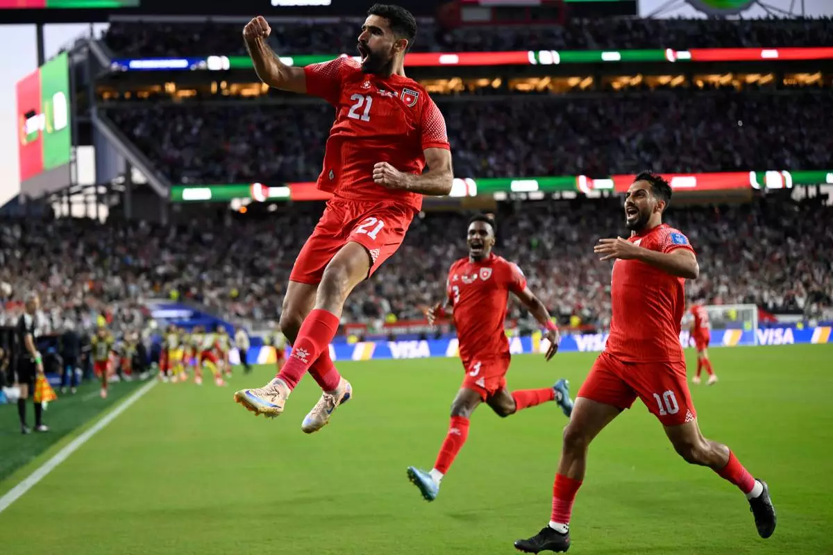Jordan's Nizar Alrashdan, left, celebrates after scoring the opening goal against Algeria during the World Cup Group J soccer match in Santa Clara, Calif., near San Francisco, Monday, June 22, 2026. (AP Photo/Eakin Howard)