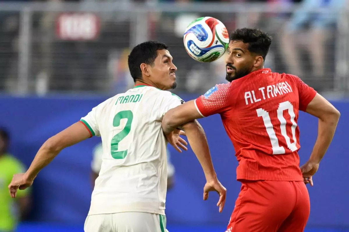 Algeria's Aissa Mandi, left, and Jordan's Mousa Altamari battle for the ball during the World Cup Group J soccer match in Santa Clara, Calif., near San Francisco, Monday, June 22, 2026. (AP Photo/Eakin Howard)